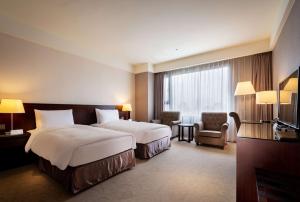 Postel nebo postele na pokoji v ubytování Lailai Hotel