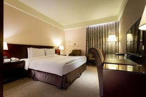 Postel nebo postele na pokoji v ubytování Lailai Hotel