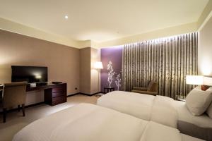 Postel nebo postele na pokoji v ubytování Lailai Hotel