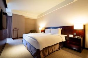Postel nebo postele na pokoji v ubytování Lailai Hotel