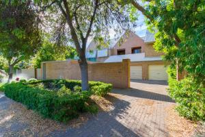 a house with a tree and a brick driveway at Adelaide Style Accommodation-Close to City-North Adelaide-3 Bdrm- FREE Parking in Adelaide