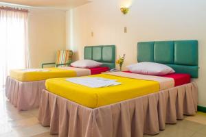 Postel nebo postele na pokoji v ubytování Benguet Prime Hotel + 8 fotografií