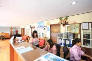 a group of women standing in a room at The Siam Guest House - SHA Extra Plus in Pattaya Central
