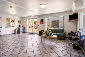 a living room with a couch and a table at Motel 6 Portland Mall - 205 in Portland