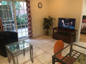 a living room with a television and a table at Beautiful New Home in Burbank 1bd in Burbank