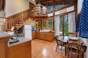 a kitchen and dining room with a spiral staircase in a house at Huckleberry House in Fort Bragg