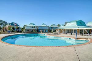 a large swimming pool in front of a building at Surf Club in Dauphin Island