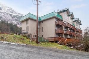 a large building on a hill next to a road at Alyeska North #400 in Girdwood