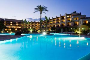 a large swimming pool in front of a hotel at Precise Resort El Rompido-The Hotel in El Rompido