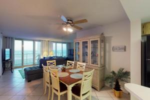 a dining room and living room with a table and chairs at Oceania Plaza & Suites in New Smyrna Beach