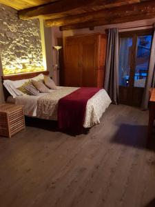 a bedroom with a bed and a large window at Agriturismo Rivet d'Or in Pragelato