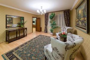 a living room with two chairs and a television at Bystrytsya Lux in Ivano-Frankivsk