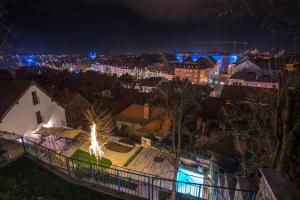 a view of a city at night with lights at Stella Sky in Ljubljana