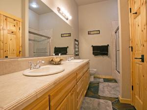a bathroom with a sink and a toilet at Crystal Springs Chalet in Sandpoint +12 photos