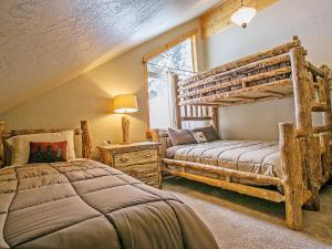 a bedroom with two bunk beds and a window at Crystal Springs Chalet in Sandpoint