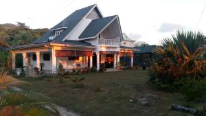 a large house with a gambrel roof at Chello's Villa in Mahe