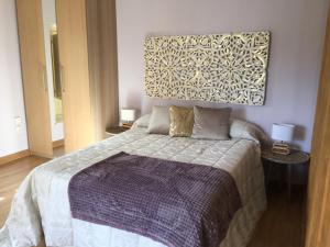 Łóżko lub łóżka w pokoju w obiekcie NATURA SUITE MÁLAGA