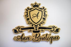 a gold royal crest with a cross and the words alma boutique at Ana Boutique in Alba Iulia