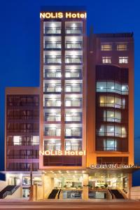 a building with a nols hotel sign on it at Nolis Hotel in Vung Tau