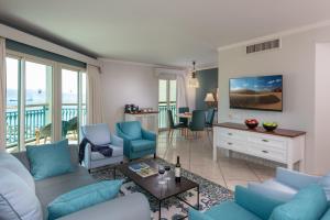 a living room with a couch and chairs at Herods Boutique Eilat a Premium collection by Fattal Hotels in Eilat