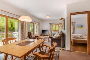 a living room with a wooden table and a dining room at Haus Bürgle in Bad Hindelang