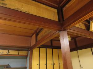 a room with wooden ceilings and yellow doors at Shitanda in Takayama