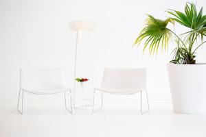 a white table and chairs and a potted plant at Dar El Marsa Hotel & Spa in La Marsa