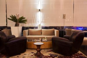a living room with two chairs and a table at Dar El Marsa Hotel & Spa in La Marsa