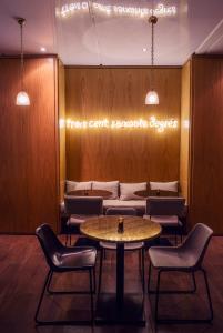 a waiting room with a table and chairs at Dar El Marsa Hotel & Spa in La Marsa