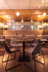 a restaurant with a table and chairs in a room at Dar El Marsa Hotel & Spa in La Marsa