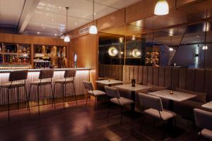 a restaurant with tables and chairs and a bar at Dar El Marsa Hotel & Spa in La Marsa