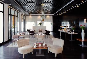 a restaurant with chairs and a table and a bar at Dar El Marsa Hotel & Spa in La Marsa