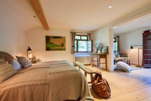 a bedroom with a large bed and a table at Hotel & Restaurant Linde in Münstertal