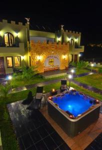 a large swimming pool in front of a house at night at Abbacy Katiana's Castelleti 2 in Limenas