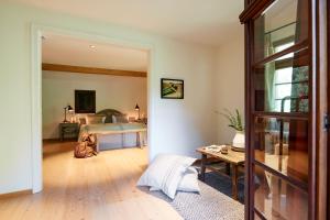 a bedroom with a bed and a table at Hotel & Restaurant Linde in Münstertal +50 photos