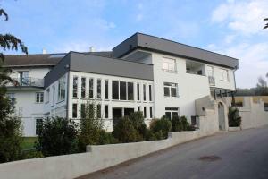 a white building with a lot of windows at Haus Pucher in Sankt Florian am Inn