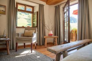 a living room with a chair and a window at Hotel & Restaurant Linde in Münstertal