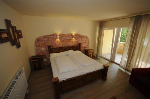 a bedroom with a large bed with a brick wall at Seehotel Europa in Schwanau +63 photos