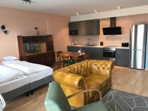 a living room with a couch and a kitchen at Silesia Apartment Eliza in Bytom