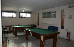 a room with two pool tables in it at Hotel Capriccio São Caetano in São Caetano do Sul