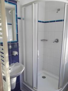 a bathroom with a shower and a sink at Hotel Jestřábí in Černá v Pošumaví