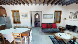 a kitchen and living room with a table and chairs at Stou Kir Yianni in Omodos