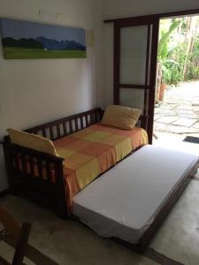 two beds sitting next to each other in a bedroom at Vila do Sossego in Ubatuba