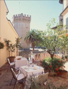 un patio con tavolo, sedie e castello di Locanda di Porta Antica a San Benedetto del Tronto