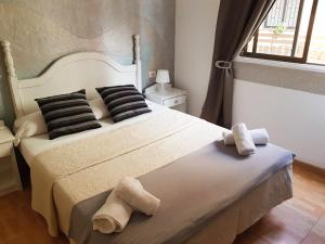 a bed room with a white bedspread and pillows at Hotel Horizonte in Santa Cruz de Tenerife