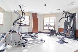 un gimnasio con varias cintas de correr y máquinas elípticas en Apartment with Terrace and Sauna by Grand Apartments, en Sopot