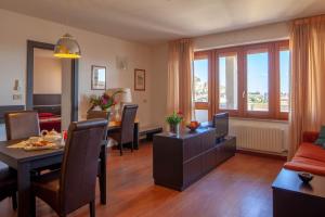 a living room with a couch and a dining room at Marbela Apartments & Suites in Palermo