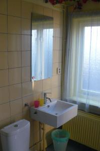 a bathroom with a sink and a toilet at Amsterdam Beach Apartment in Zandvoort +40 photos