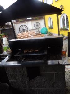 an outdoor grill with benches in a yard at Penzion U Urbanů in Němčice