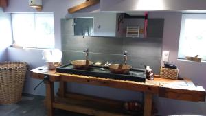 クソンリュプト・ロンジュメールにあるspa et wellnessのキッチン(銅製の器2つを入れたシンク付)